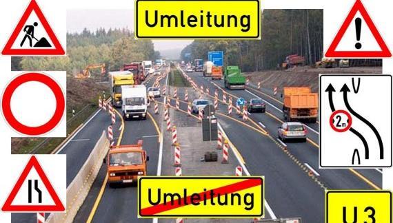 Das Bild zeigt eine Autobahnbaustelle mit vielen Fahrzeugen und rundherum Verkehrsschildern im Zusammenhang mit Straßenbaustellen.
