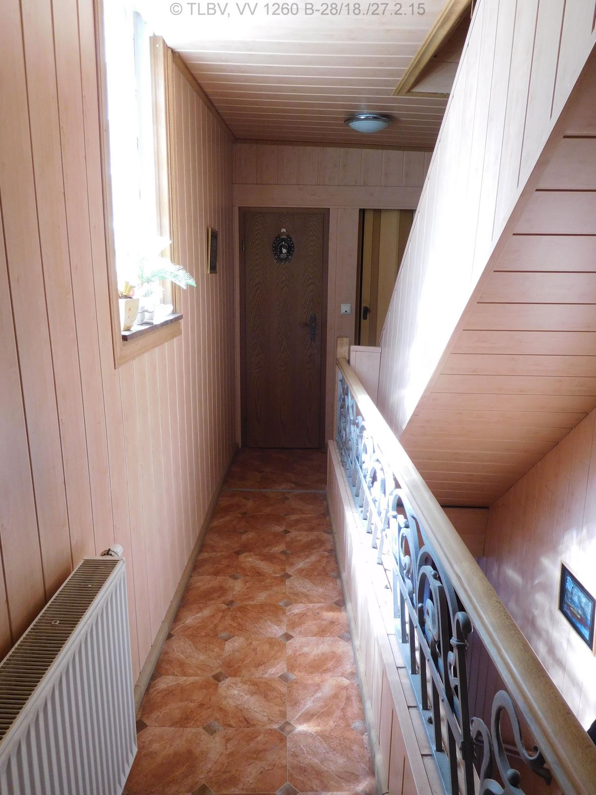 Flur in einer mittleren Etage, es geht eine Treppe sowohl hoch als auch herunter