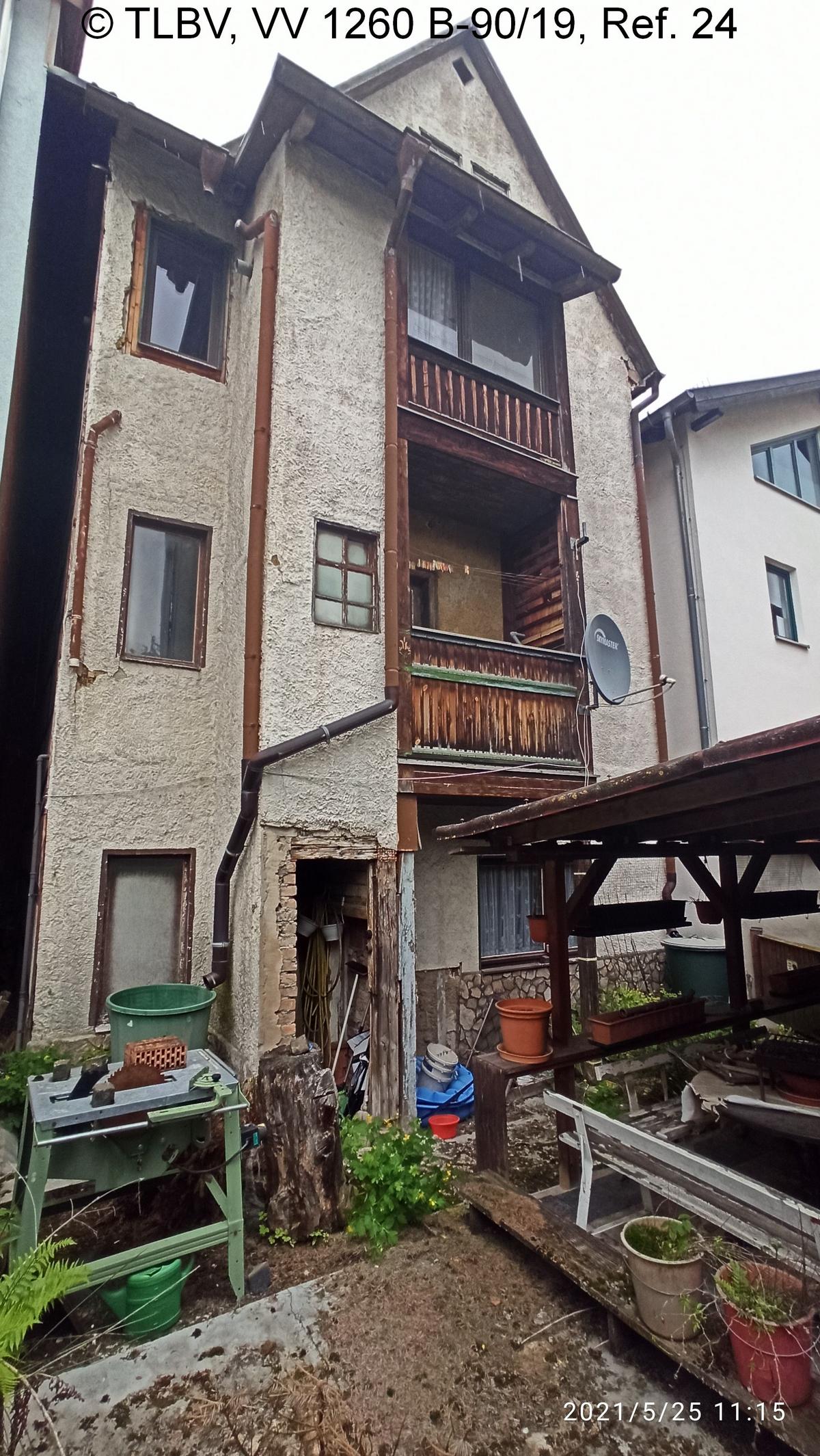rückseitige Hausansicht, Giebelseite; 3 Vollgeschosse plus teilausgebautes Dach; im EG Terrasse, 1. und 2 OG zwei Balkone mit Holzbalustrade