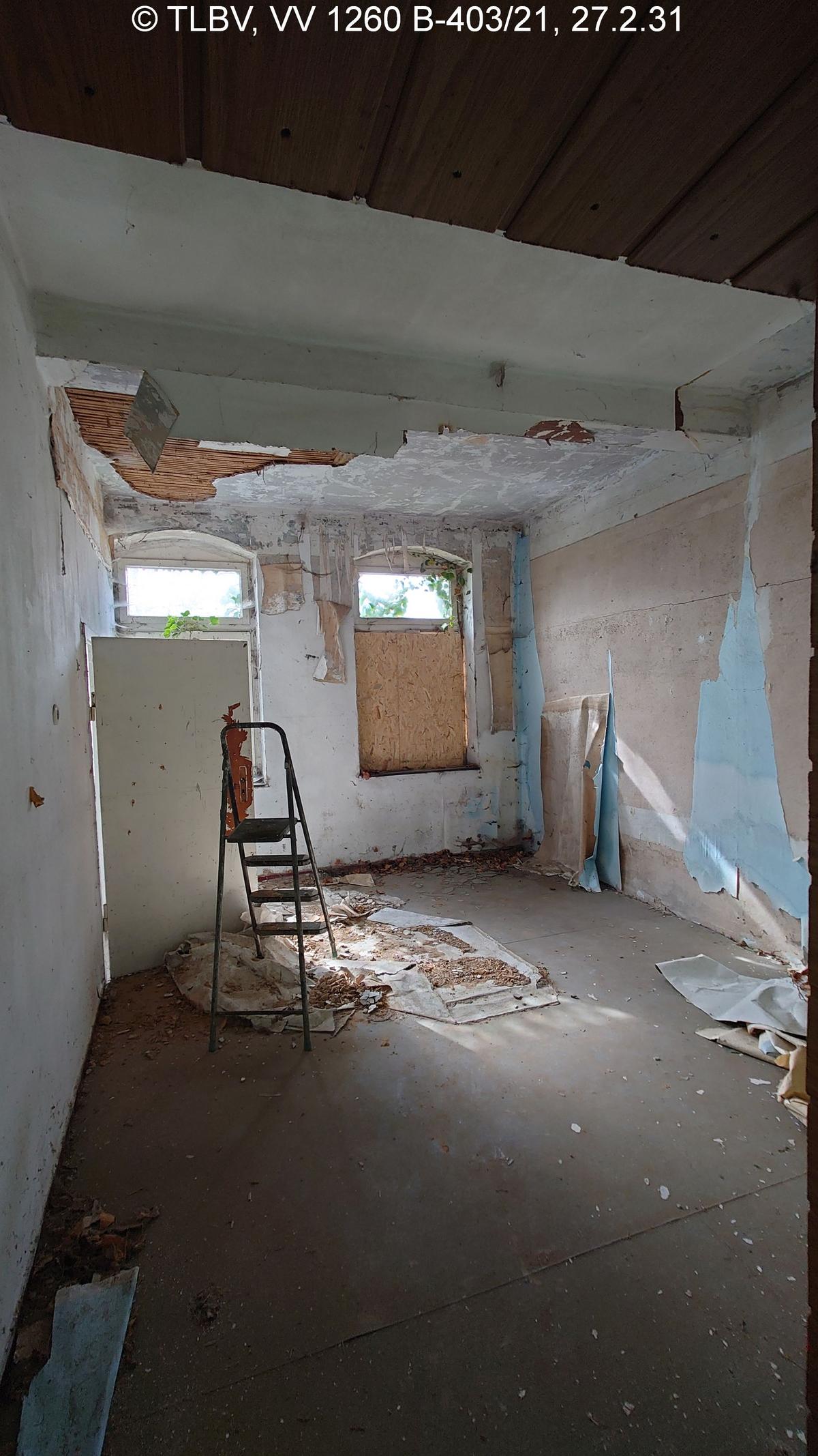 Zimmer mit zwei Fenstern und mind. 1 Innentür, Deckenputz abgängig, Fensterscheibe fehlt, stattdessen mit MDF-Platte versehen, Tapeten fallen herunter